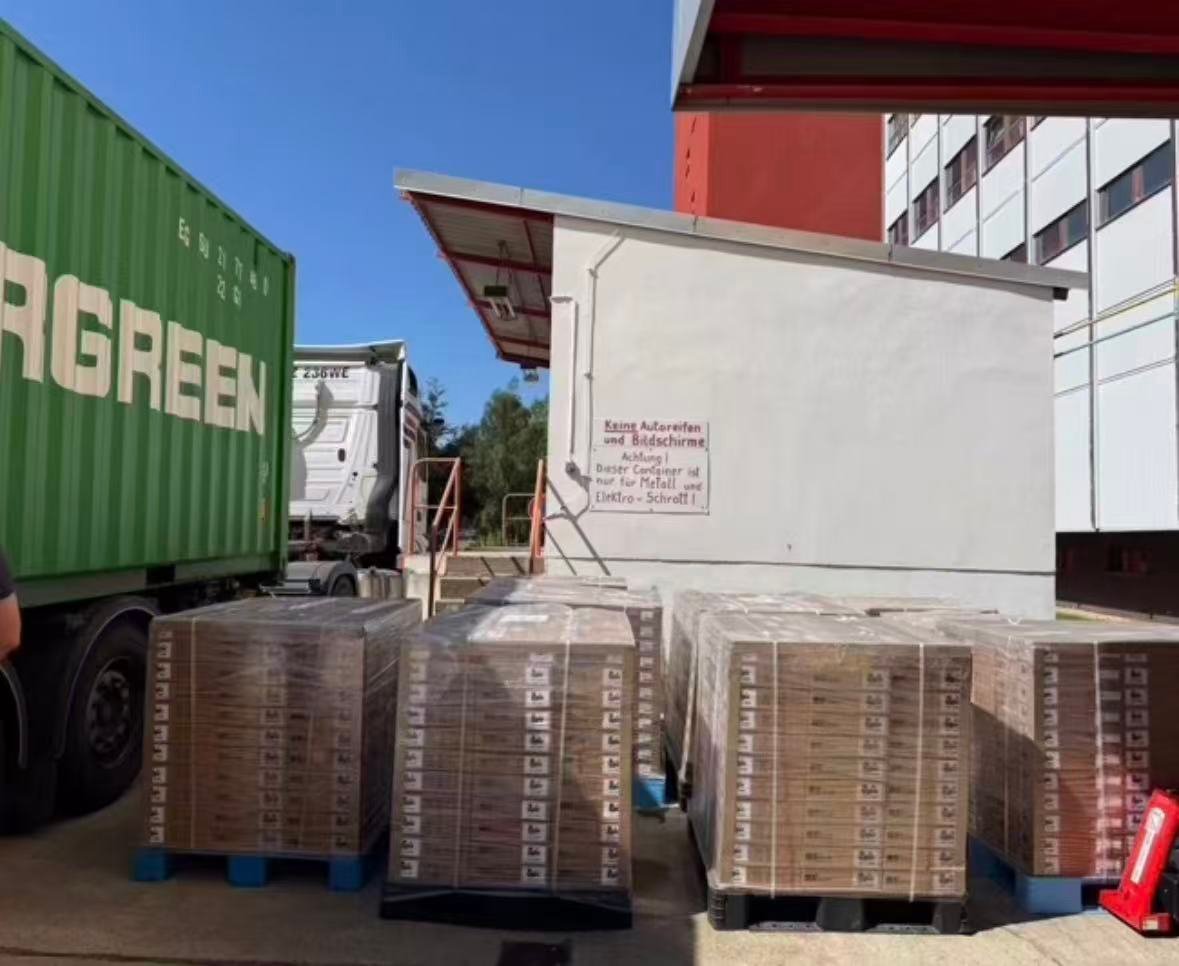 Palletized battery-cell cartons being unloaded from a container in Poland