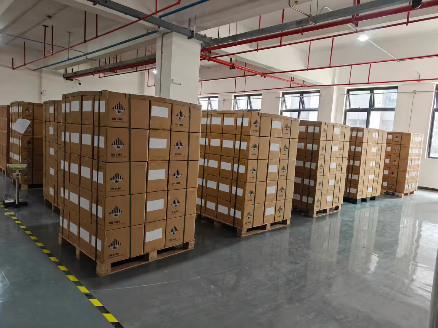 Packed MB31 battery cell cartons on pallets in China before shipment to Poland, shipping labels obscured
